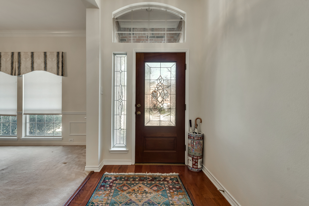    Entry has Lead Glass Inlaid Front Door 