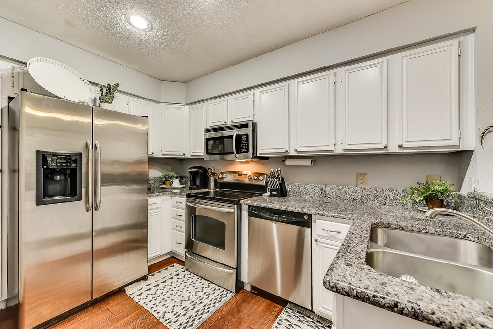    Chef s Kitchen with Granite Countertops and Freshly Painted White Cabinetry 