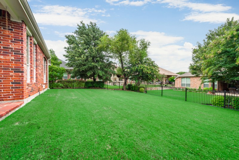    Grassy Backyard with Iron Fencing 