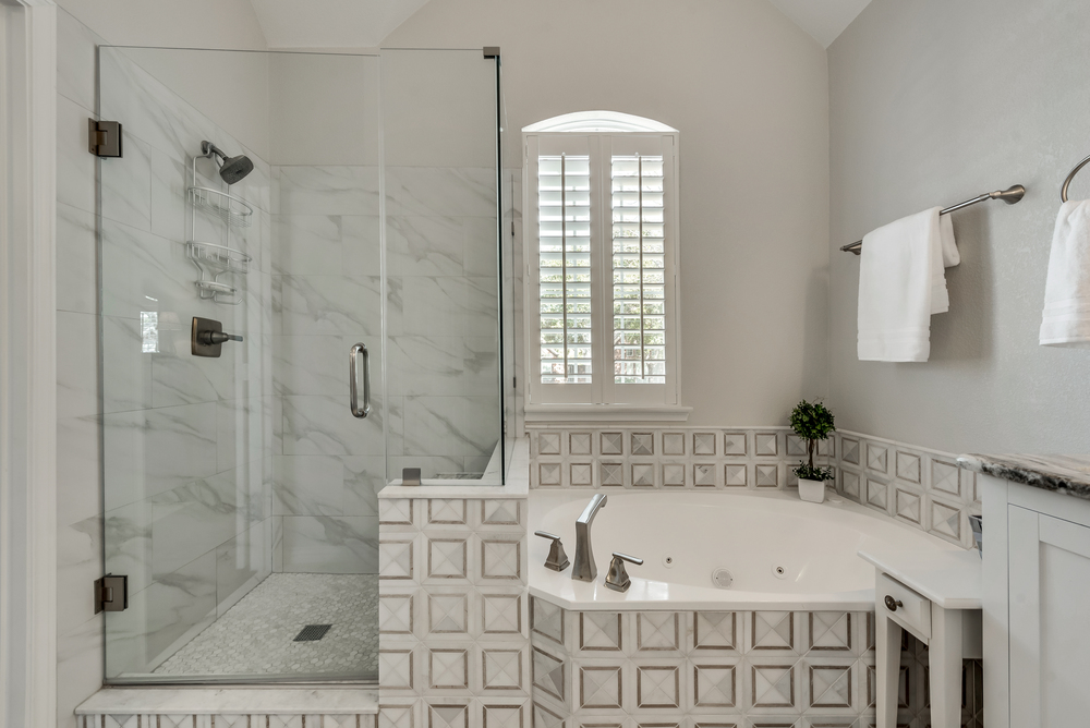    Spa Like Master Bathroom with Jetted Tub and Seamless Glass Shower 