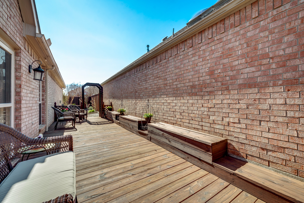    Back Deck with Built In Benches Leads to Grassy and Landscaped Backyard 