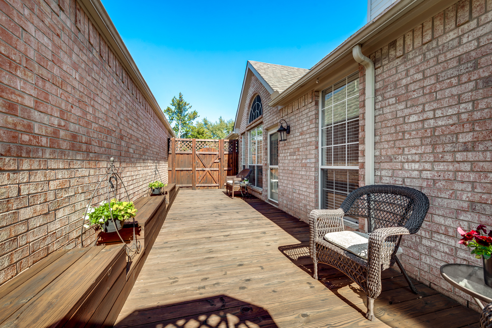    Back Deck with Built In Benches Leads to Grassy and Landscaped Backyard 