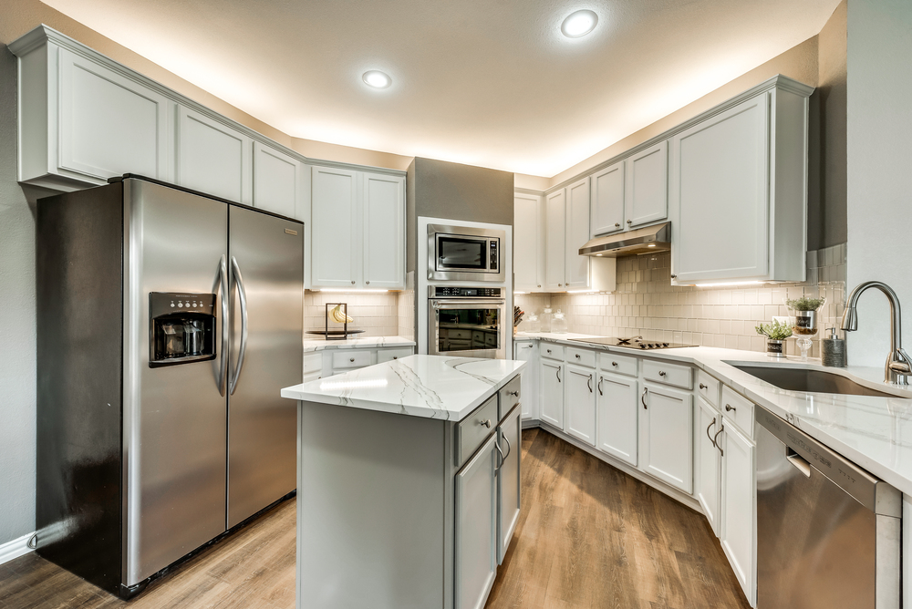    Abundance of White Cabinetry with Over and Under Mount Lighting 