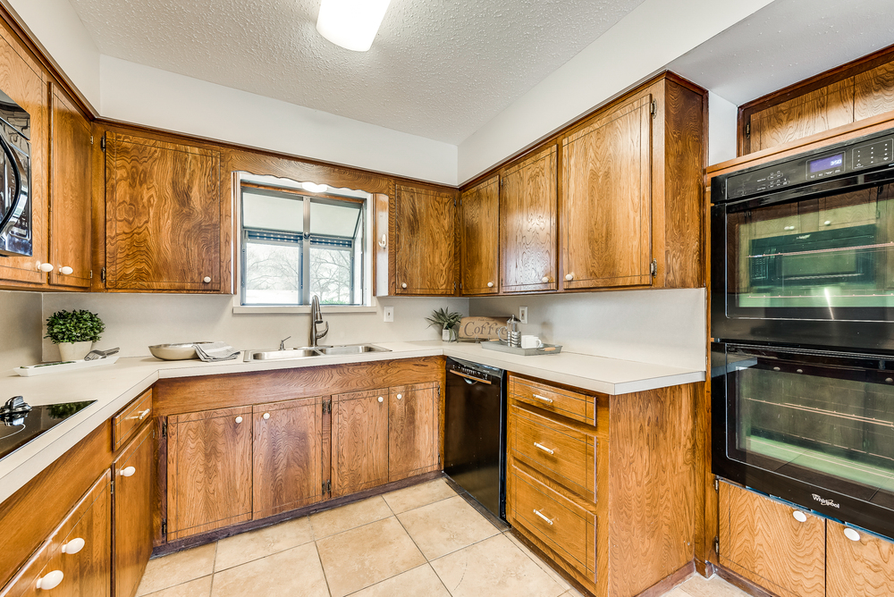    Kitchen has Wood Cabinetry and Double Ovens 