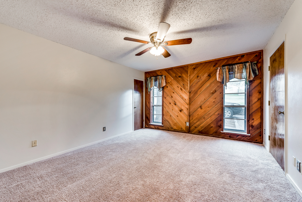    Master Bedroom with Wooden Accent Wall and Walk In Closet 