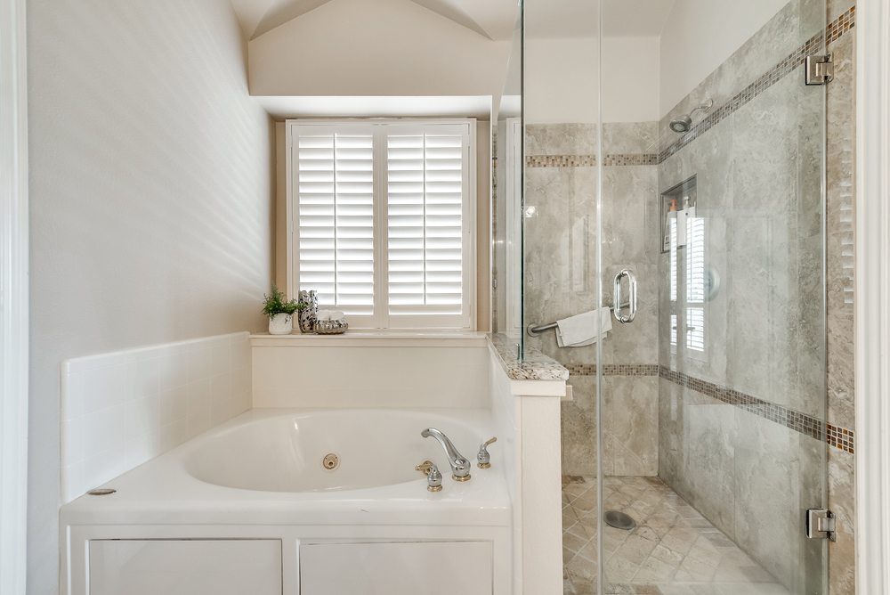    Master Bathroom with Jetted Tub and Seamless Glass Shower 