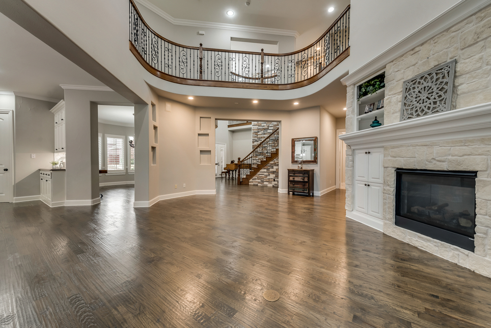    Family Room with Gorgeous See Through Fireplace Flanked by Built In Cabinets 