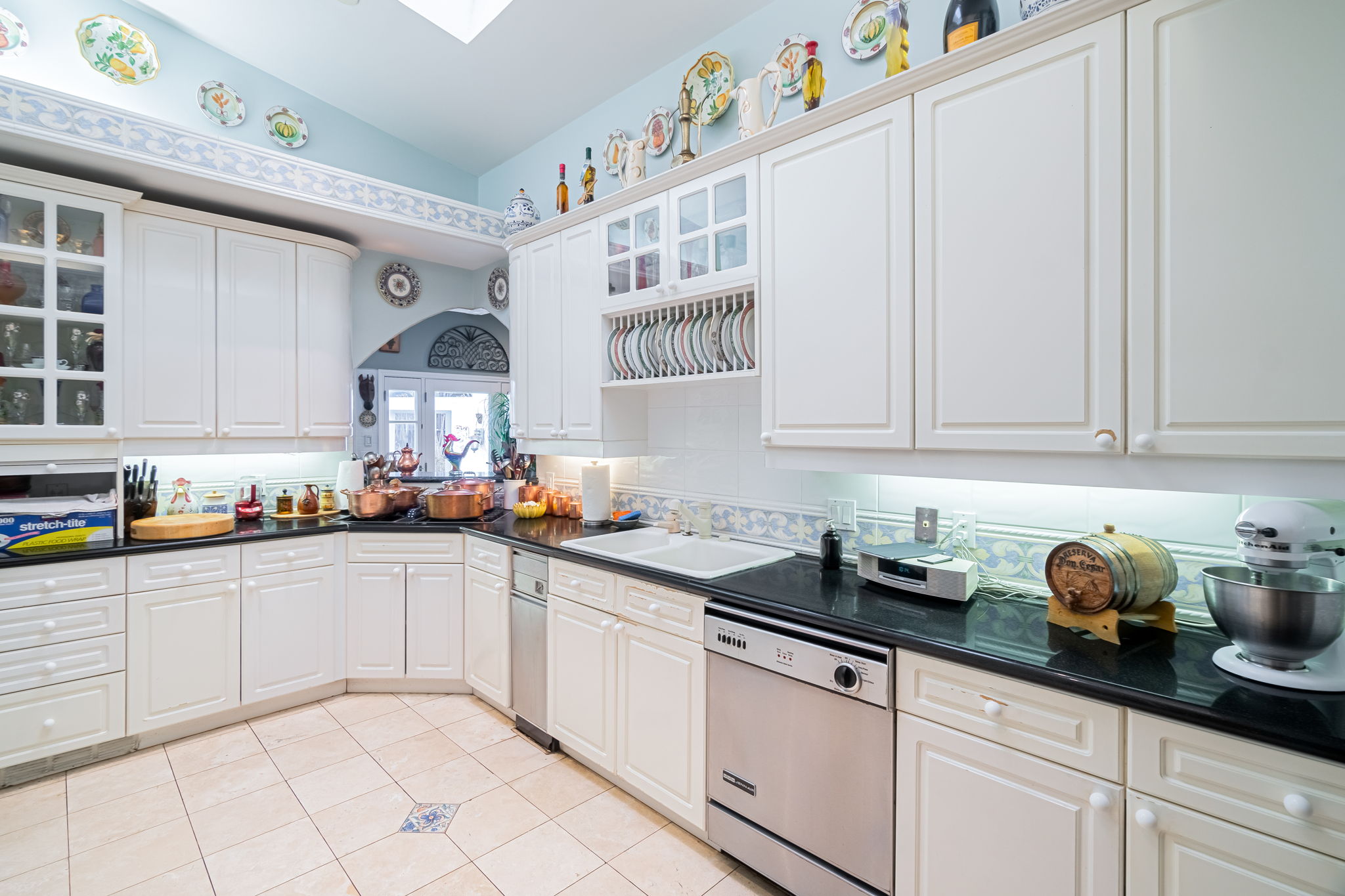    Chef s Kitchen has Granite Countertops White Cabinetry and Great Natural Light 