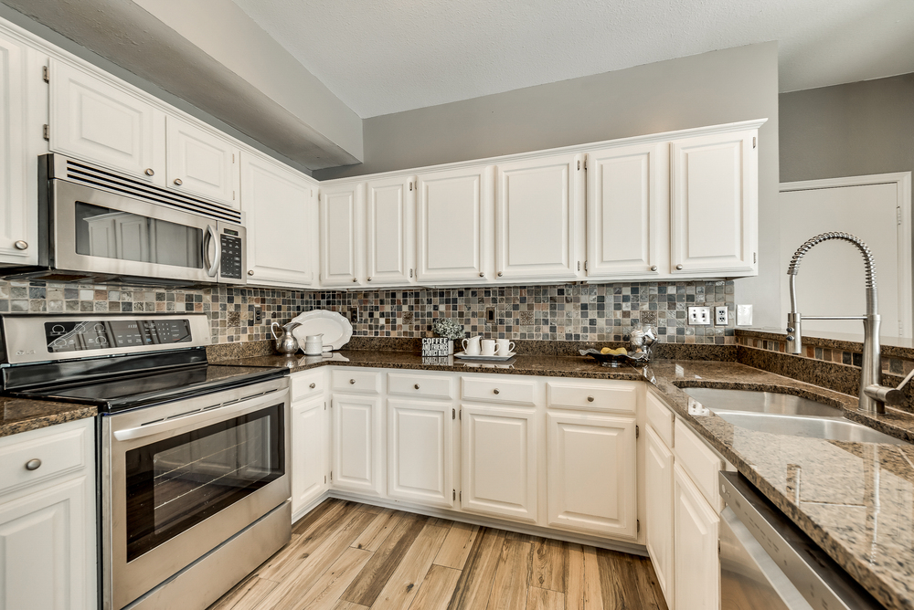    Chef s Kitchen with White Cabinetry and Stainless Appliances 