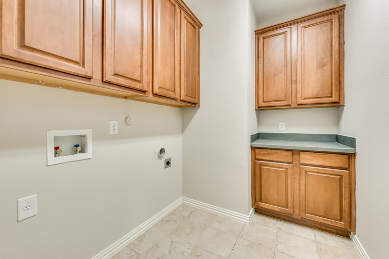    Utility Room with Counter Space and Cabinets 