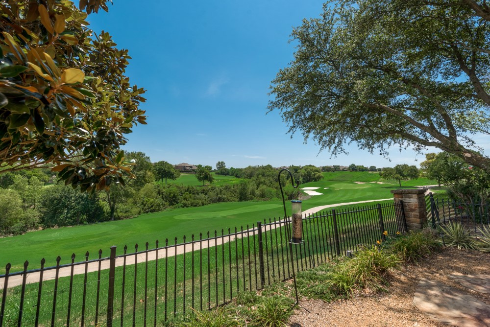    Backyard Overlooks Golf Course with Wrought Iron Fence 