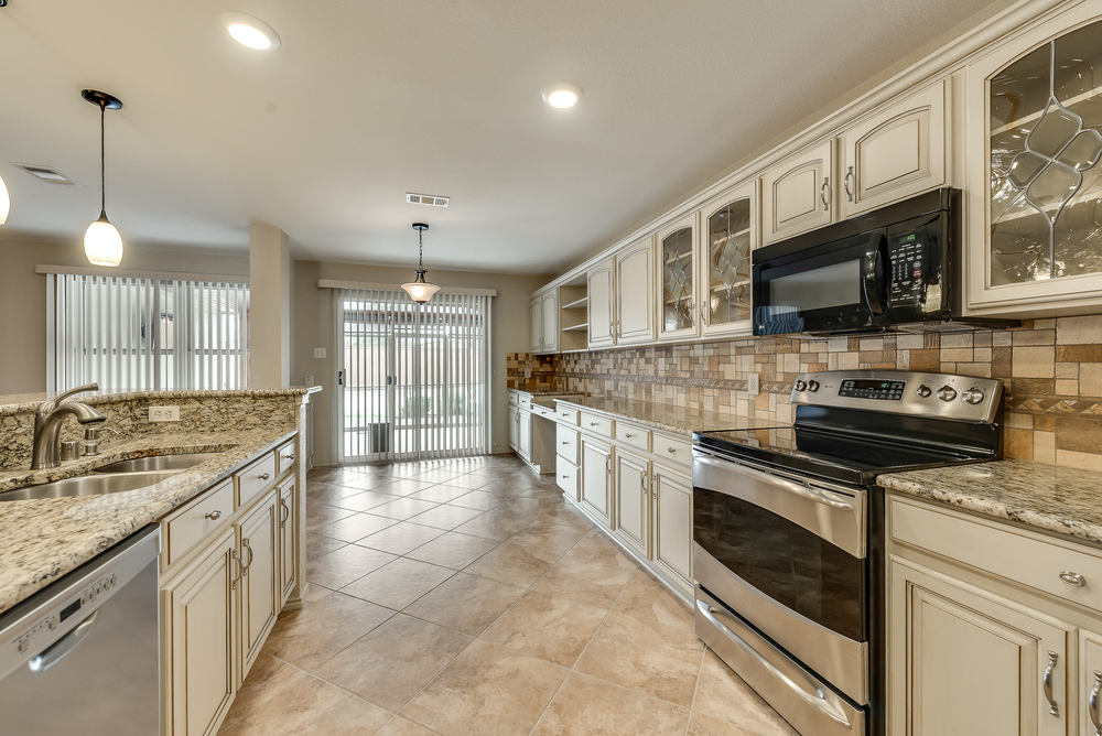    Antiqued Cabinets with Glass Door Accents 